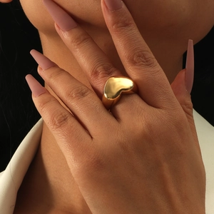 Polished gold heart open ring for women with minimalist chunky design on model's hand