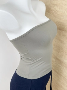 Detail of grey-green rib-knit bandeau top showing texture and fit on a mannequin