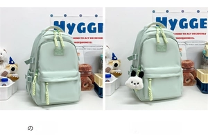 Detailed view of mint green waterproof nylon school backpack with panda pendant accessories