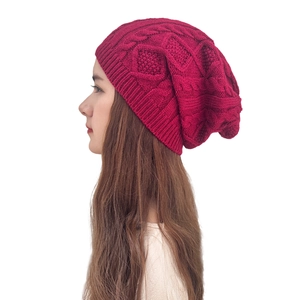Close-up of wine red chunky knit beanie showing detailed diamond texture and ribbing