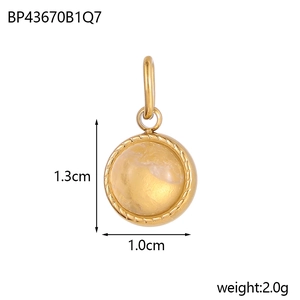 Detail view of round gold pendant with yellow stone showing 1.3cm x 1.0cm dimensions