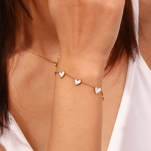 Elegant 18K gold-plated stainless steel bracelet featuring five white heart pendants