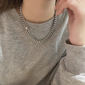 Polished silver cuban link chain necklace in titanium steel on male model wearing hoodie