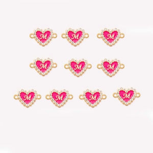 Detail of 10 pink enamel heart charms with gold M letter and rhinestones for DIY bracelets