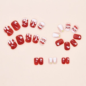 Detail of Christmas press-on nails set with Santa Claus and snowflake motifs