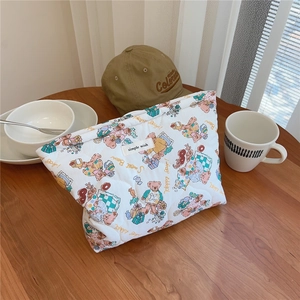 Detail of quilted cotton pouch featuring cute cartoon bears and Sweet Bear text patterns
