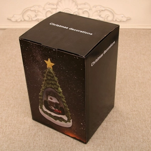 Elegant black Christmas gift box featuring a gold tree design and decorative white lettering