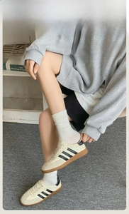 Close-up of minimalist retro sneakers with suede panels and signature side stripes