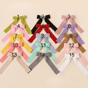 Grid display of fifteen corduroy gold polka dot hair bows with color numbering