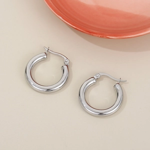 Detailed view of polished thick silver hoop earrings with secure click-top closure