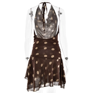 Detail of a brown polka dot halter dress featuring an open back and breathable fabric