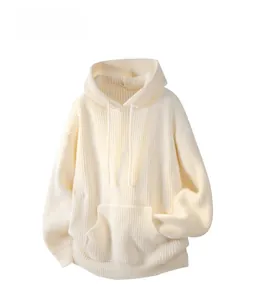 Close-up detail of cream knit hoodie showing heavy vertical rib texture and kangaroo pocket