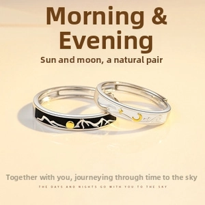 Detailed view of sun and moon couple rings in vintage silver finish on beige backdrop