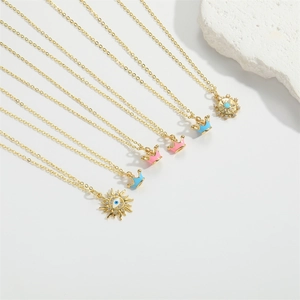 Detail of six-piece golden necklace set with enamel evil eye and crown charms