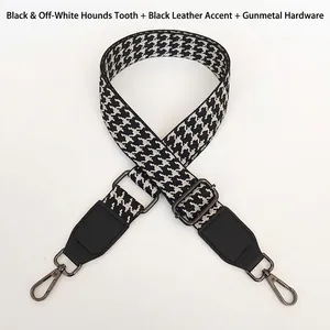Adjustable black and white houndstooth strap with gunmetal hooks and leather detail