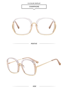 Detail view of champagne oversized round frames with gold metal temples and blue light lens
