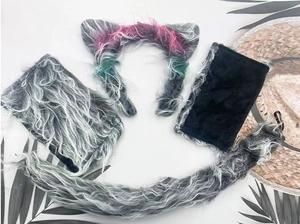 Macro detail of fluffy grey faux fur wolf ears and tail set with color gradient accents