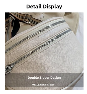 Detailed close-up of beige lychee grain leather waist bag with dual silver metal zippers
