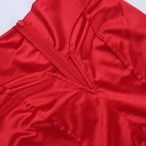 Detailed close-up of glossy red satin fabric with a matching seamless hidden zipper