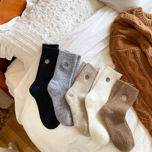 Detailed set of five winter knit socks featuring delicate rose embroidery on the cuffs