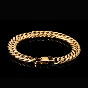 Detailed close-up of golden stainless steel Cuban chain bracelet with secure box clasp