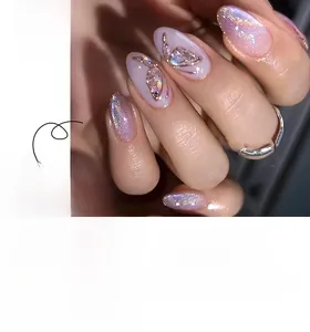 Detail of almond-shaped purple cat eye press-on nails with 3D metallic butterfly accents
