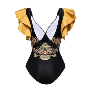 Detail of black one-piece swimsuit with yellow ruffled straps and gold baroque print