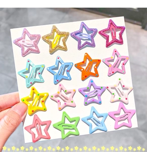 Close-up of sixteen colorful star-shaped metal snap hair clips with glitter and polka dots