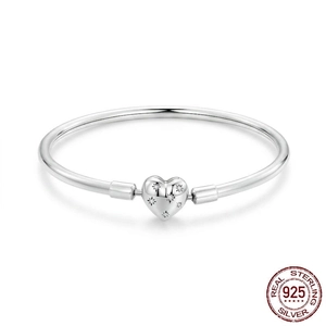 Minimalist S925 sterling silver bangle featuring a starburst zircon heart charm on white background