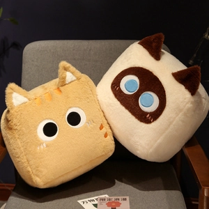 Close-up of square plush cat pillows with soft faux fur texture and embroidered eyes