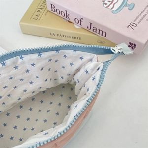 Detail of pink quilted pencil case with blue star lining and high-quality blue zipper