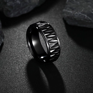 Detailed view of black stainless steel ring with geometric faceted texture for men