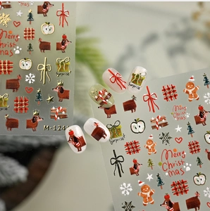 Detail of Christmas nail stickers with gingerbread man and golden dachshund patterns