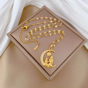 Detailed macro view of gold crescent moon pendant with Love you forever engraving