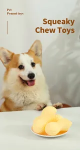 Nahaufnahme von Erdnuss-Hundespielzeug in Schale mit Corgi im Hintergrund für Kauspaß