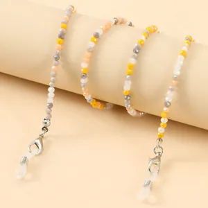 Macro view of colorful faceted glass beads and silver lobster clasps on eyewear chain