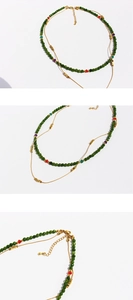 Detailed close-up of double-layer beaded necklace showing green stones and lobster clasp