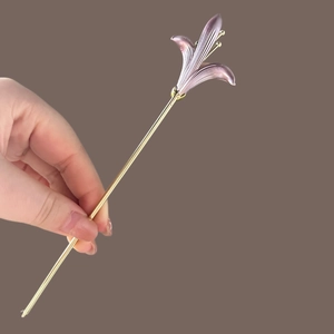 Detailed view of elegant purple lily hair pin with golden alloy petals and floral texture