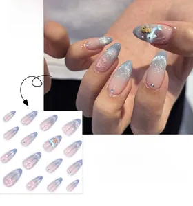 Detail of gradient blue cat-eye press-on nails with 3D dolphin and floral accents