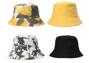 Detailed flat lay of four unisex cotton bucket hats in tie-dye and solid color options