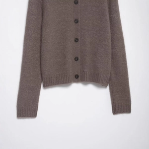 Brown knit cardigan with faux fur texture lapel and elegant round black button closure