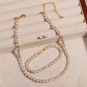 Detailed set of gold-plated necklace, bracelet and earrings with heart-shaped crystals