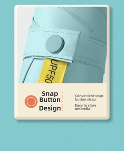 Detail of light blue umbrella strap with snap button and UPF 50+ UV protection label