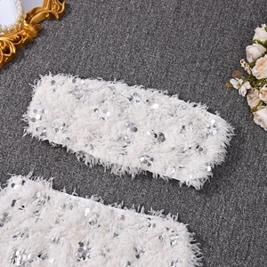 Detailed view of white faux feather and sequin tube top for party dress set