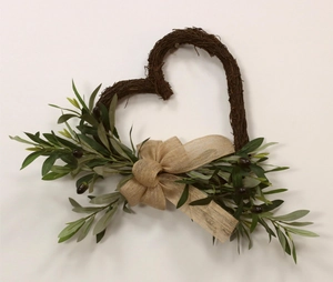 Detail of heart-shaped woven branch wreath with olive leaves and burlap bow decor