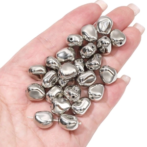 Detailed macro shot of silver CCB irregular pebble beads for DIY jewelry making
