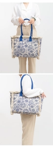 Split view of large floral canvas tote bag with fringe detail and blue handles