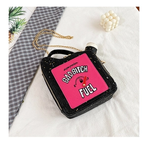 Macro shot of glitter fuel can shaped crossbody bag with chain strap and embroidery