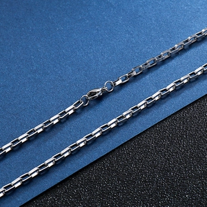 Detailed macro view of silver stainless steel box chain with a secure lobster clasp