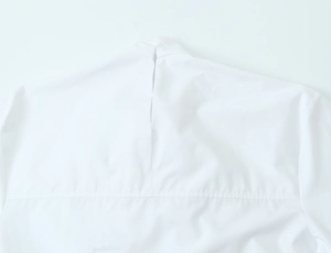 Detail of white blouse featuring back neckline slit and horizontal shoulder stitching